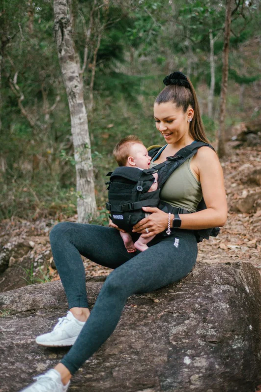 mother hiking with son in baby carrier